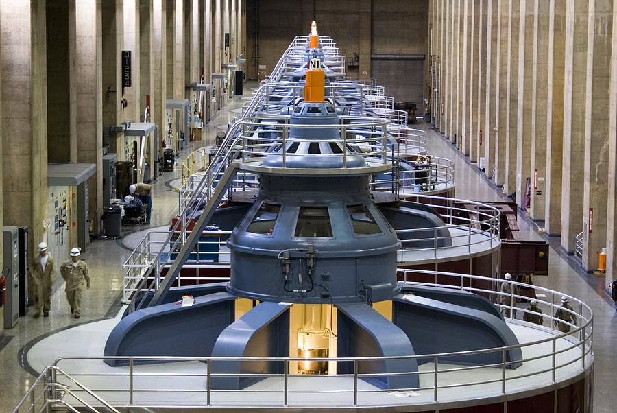 At the Hoover Dam, water flows underneath this long hall and turns these giant turbines.